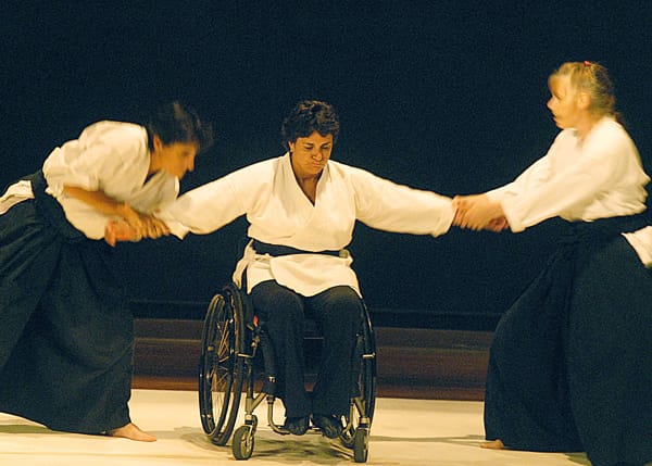Molly Sacco Hale, martial artist in wheelchair demonstrating a judo move