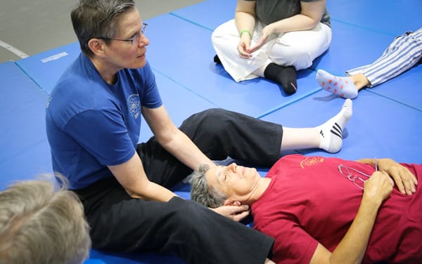 Instructor demonstrating a massage technique.