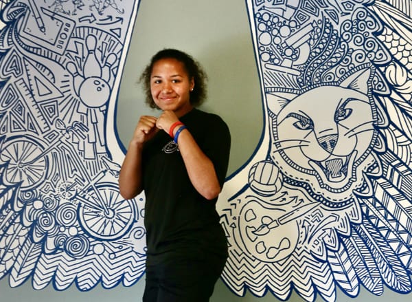 smiling girl with fists raised