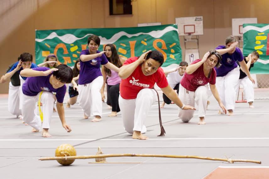 two people sparring, the t-shirt that one person is wearing reads, Sisterhood is Powerful